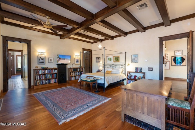 bedroom featuring beam ceiling and dark wood-type flooring