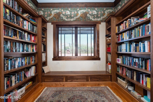 sitting room featuring hardwood / wood-style floors and a water view