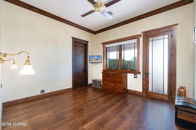 foyer with ceiling fan, dark wood-type flooring, and ornamental molding