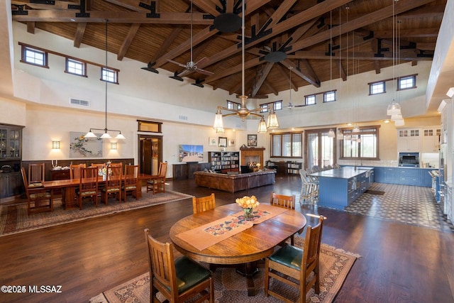 dining room with wooden ceiling, high vaulted ceiling, ceiling fan, beamed ceiling, and dark hardwood / wood-style flooring