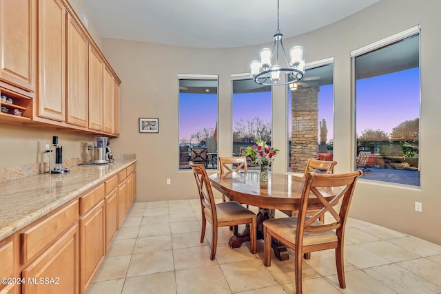 tiled dining space featuring a notable chandelier