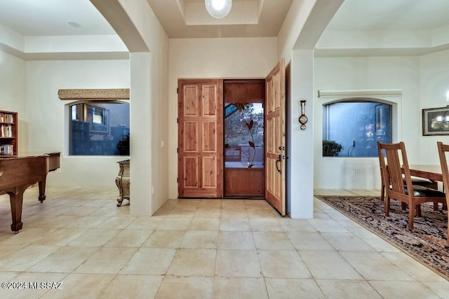 foyer entrance featuring a raised ceiling