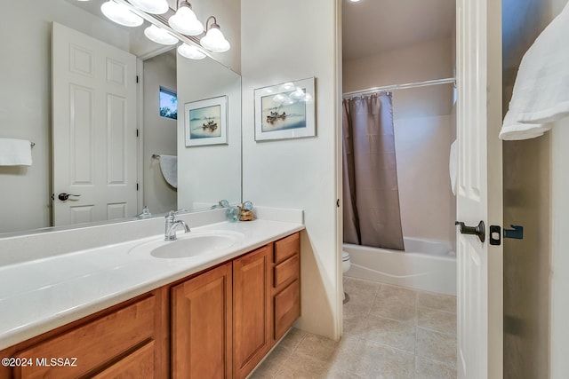 full bathroom featuring vanity, shower / bath combo with shower curtain, and toilet