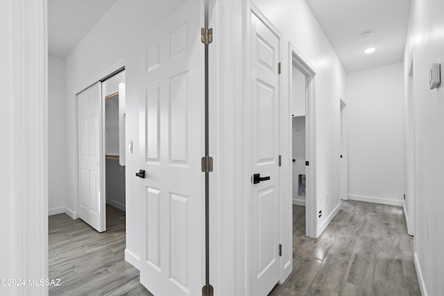 hallway with light hardwood / wood-style flooring