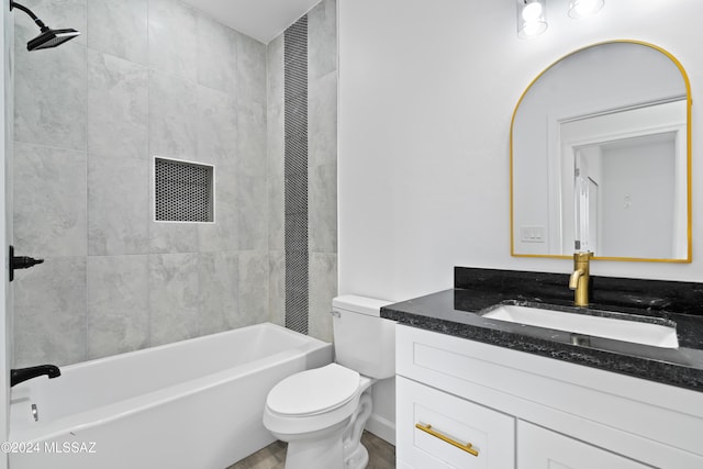 full bathroom featuring vanity, toilet, and tiled shower / bath