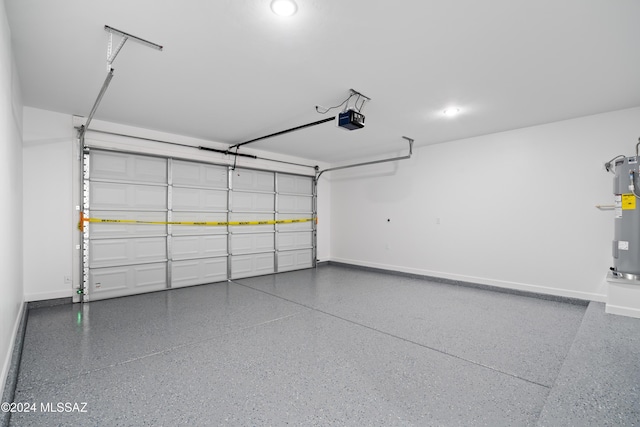 garage featuring electric water heater and a garage door opener