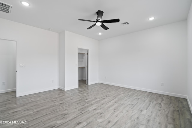 empty room featuring ceiling fan and light wood-type flooring