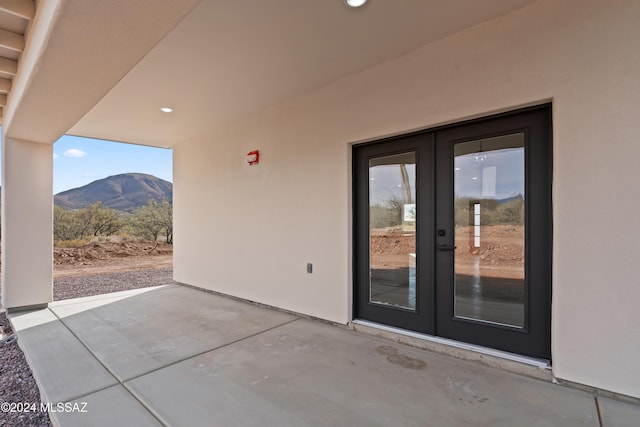 view of patio / terrace featuring a mountain view and french doors