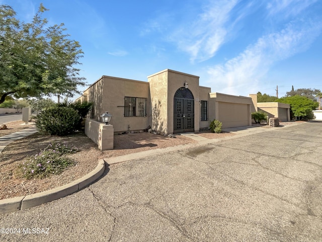 adobe home featuring a garage