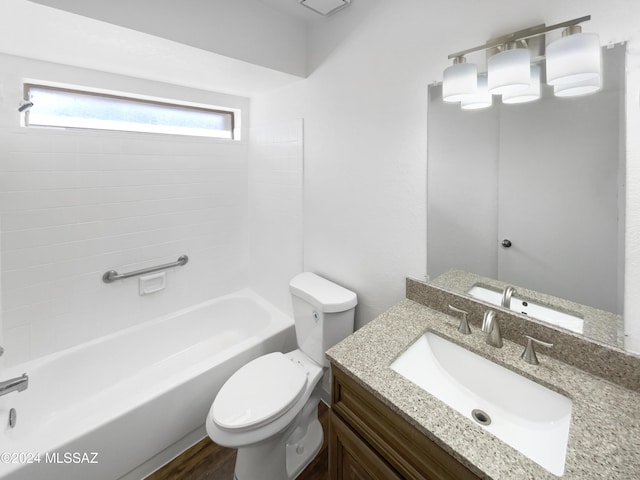 full bathroom with tiled shower / bath, toilet, vanity, and hardwood / wood-style flooring