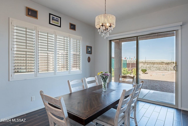 dining space featuring a healthy amount of sunlight and an inviting chandelier