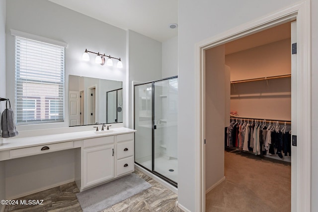 bathroom with plenty of natural light, vanity, and walk in shower