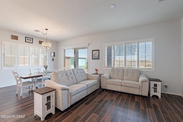 living room with a healthy amount of sunlight and a chandelier