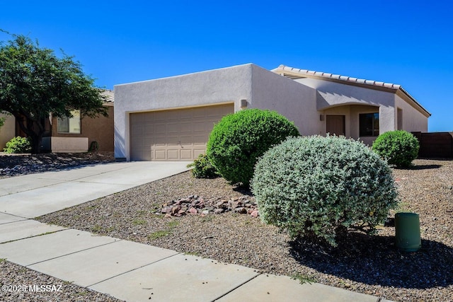 pueblo-style home with a garage