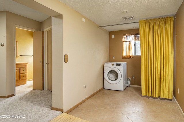 washroom with visible vents, washer / dryer, a textured ceiling, and laundry area