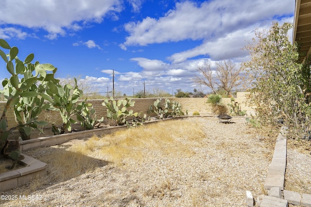 view of yard featuring a fire pit and a fenced backyard