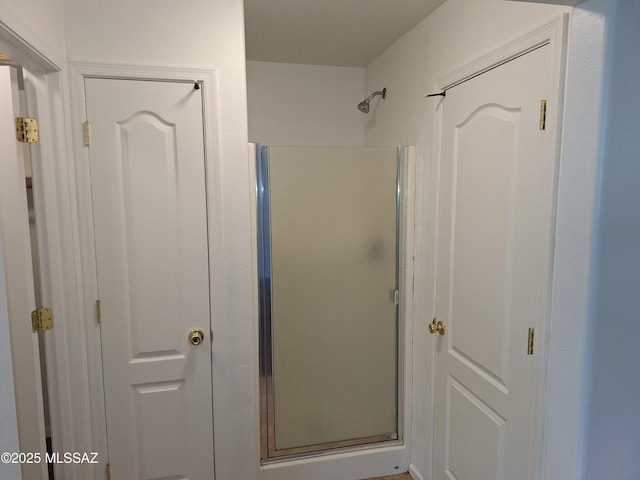 bathroom with a shower with door