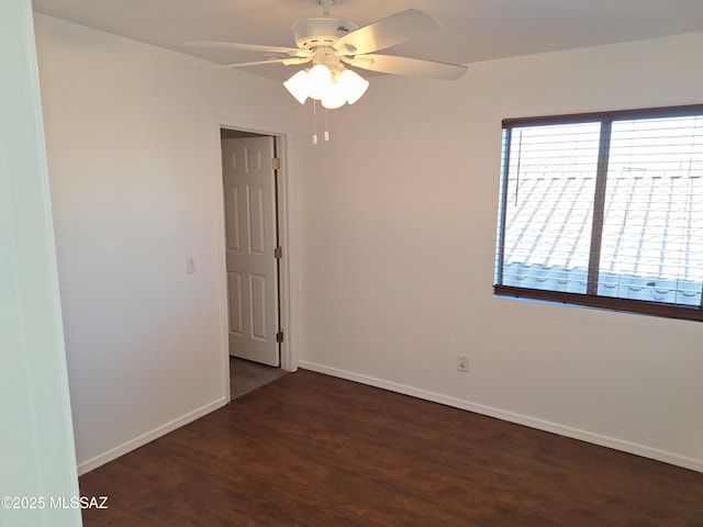 unfurnished room featuring dark hardwood / wood-style floors and ceiling fan