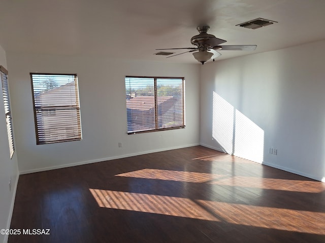 spare room featuring dark hardwood / wood-style flooring and ceiling fan