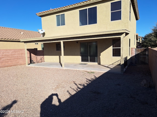 back of property featuring a patio area