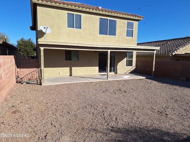 back of property with a patio