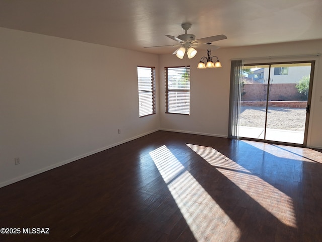 empty room featuring ceiling fan and dark wood-type flooring