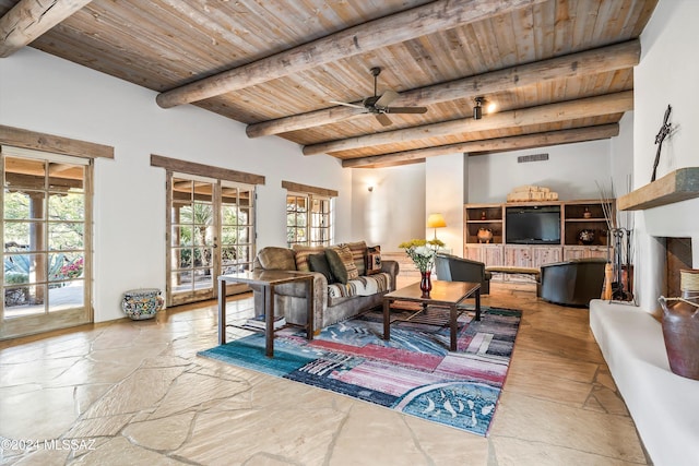 living room with beam ceiling, ceiling fan, french doors, and wood ceiling