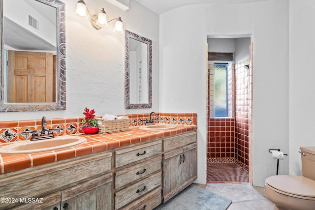 bathroom with decorative backsplash, vanity, and toilet