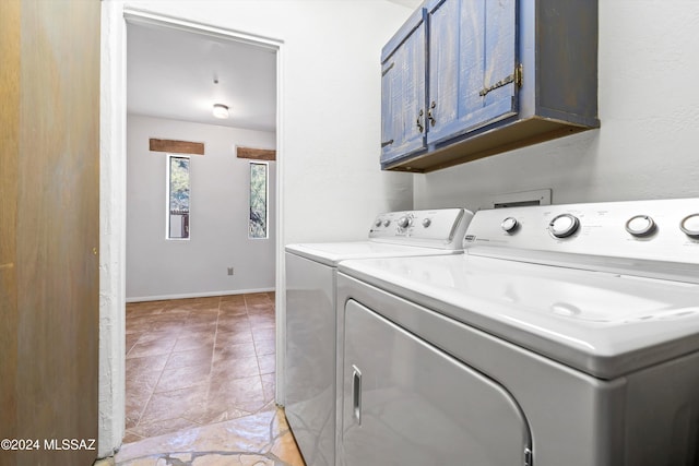 laundry area featuring cabinets and washing machine and clothes dryer