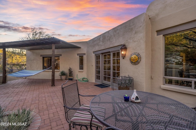 patio terrace at dusk with a pergola