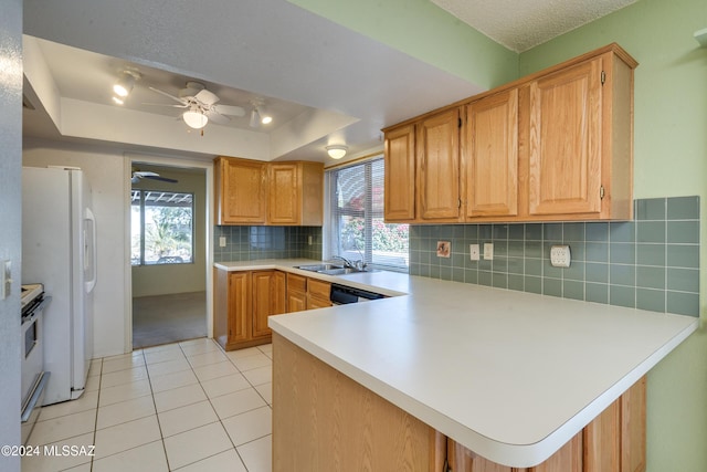 kitchen featuring light tile patterned floors, a peninsula, white appliances, light countertops, and a tray ceiling