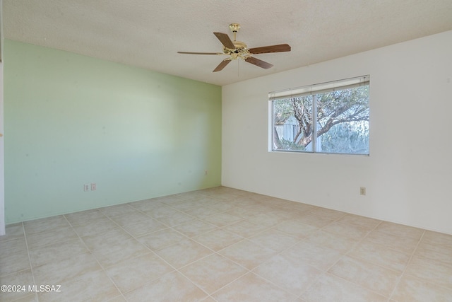 spare room featuring a ceiling fan and a textured ceiling