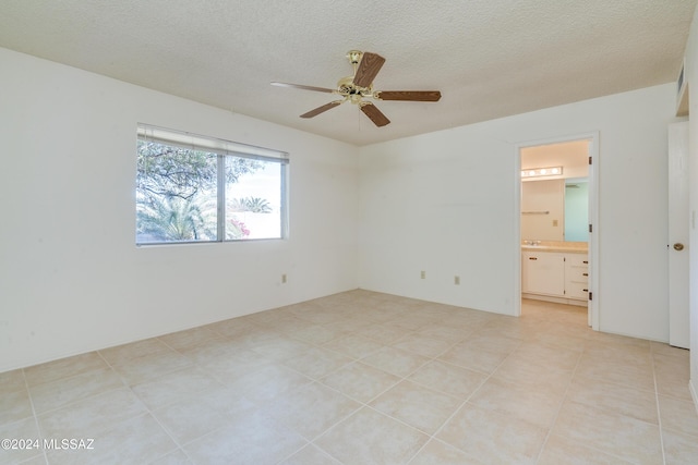 unfurnished bedroom with a ceiling fan, a textured ceiling, and ensuite bathroom