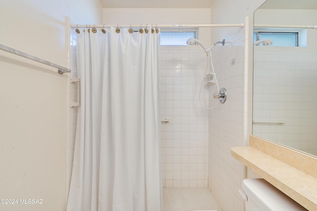 full bathroom with a stall shower and toilet