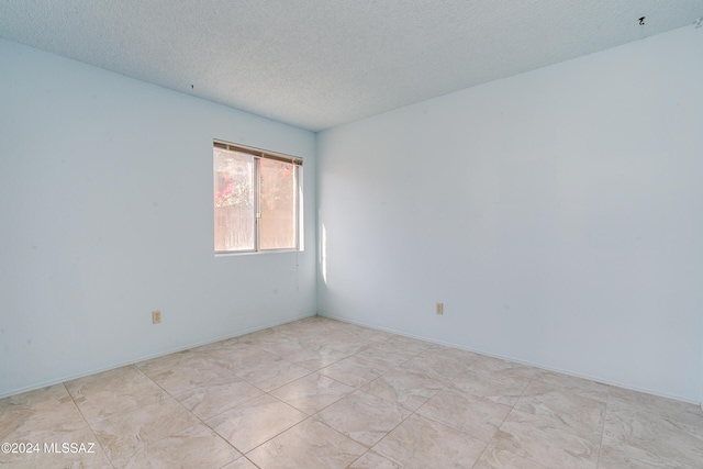 empty room featuring a textured ceiling