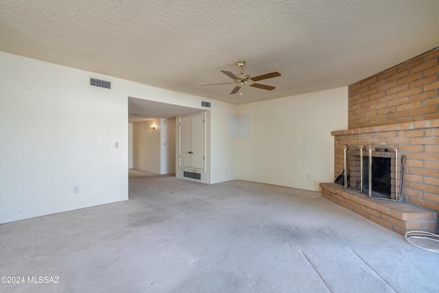 unfurnished living room with a brick fireplace, carpet, and visible vents