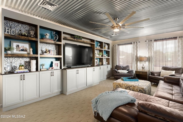 living room with ceiling fan and light colored carpet