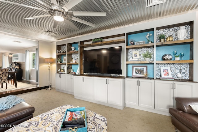 living room with ceiling fan and light colored carpet