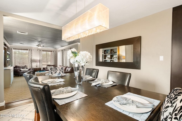 dining room with ceiling fan and light hardwood / wood-style floors