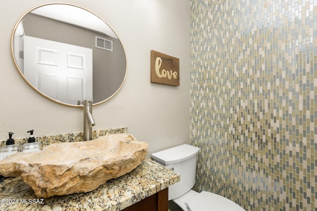 bathroom with toilet and vanity