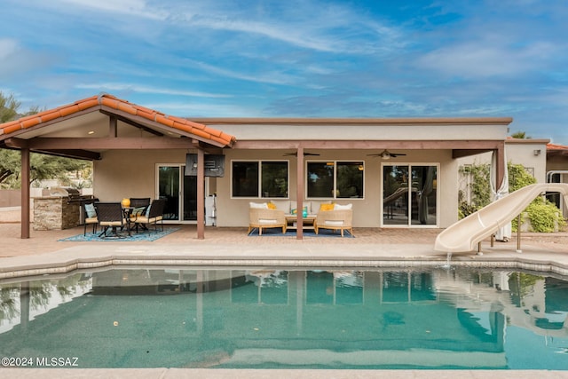 back of house with ceiling fan, exterior kitchen, and a patio