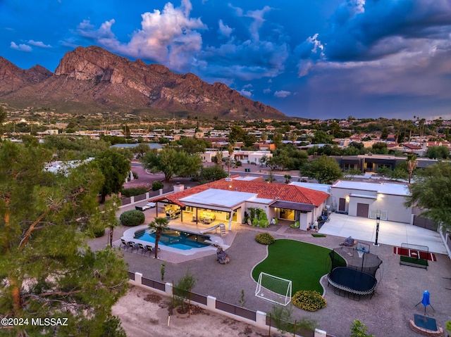 aerial view at dusk featuring a mountain view