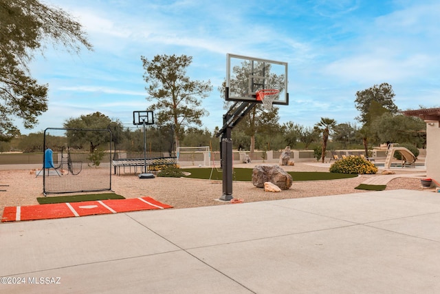 view of sport court featuring a playground and a trampoline