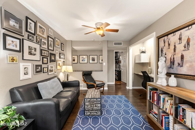 living room with ceiling fan and dark hardwood / wood-style floors