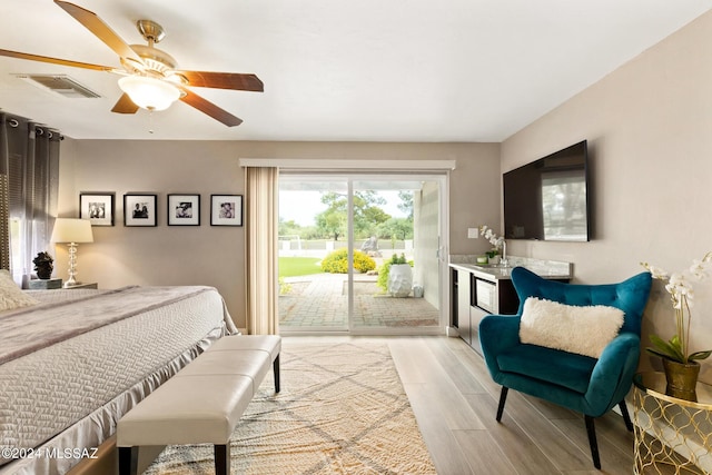 bedroom with ceiling fan, access to exterior, and sink