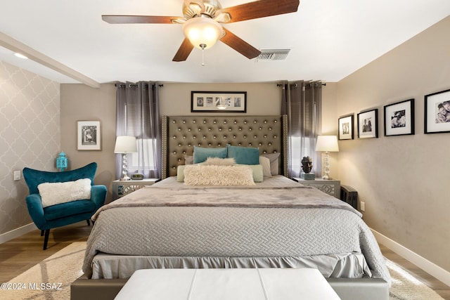 bedroom with ceiling fan and hardwood / wood-style flooring