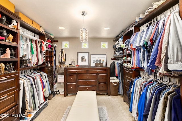 walk in closet featuring light carpet