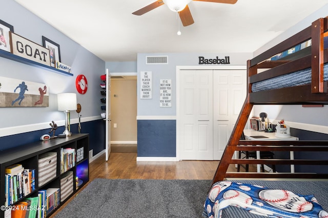 bedroom featuring ceiling fan, a closet, and dark hardwood / wood-style flooring