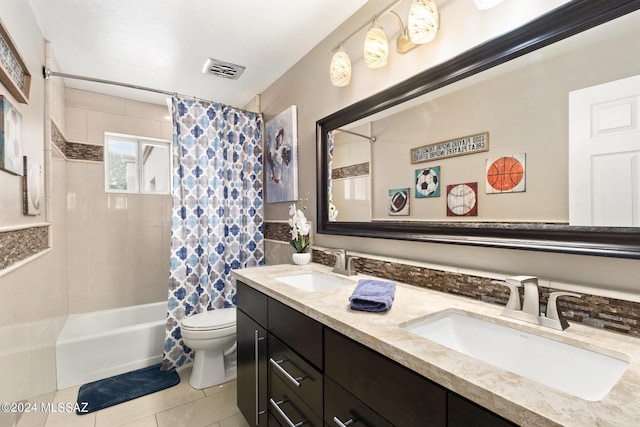 full bathroom featuring tile patterned flooring, toilet, vanity, and shower / bath combination with curtain