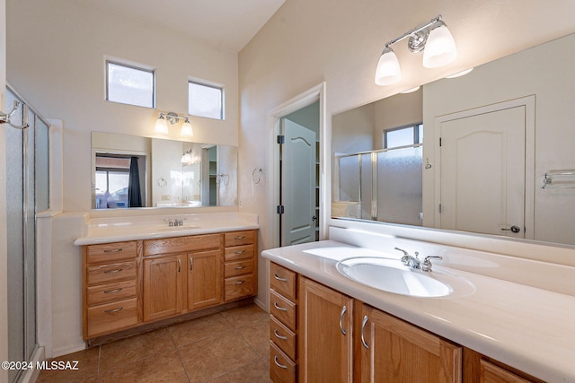 bathroom featuring tile patterned floors, vanity, and an enclosed shower